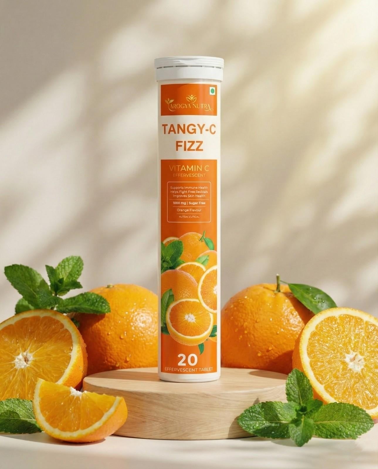 Tangy-C Fizz vitamin C supplement with oranges and mint leaves on a light background