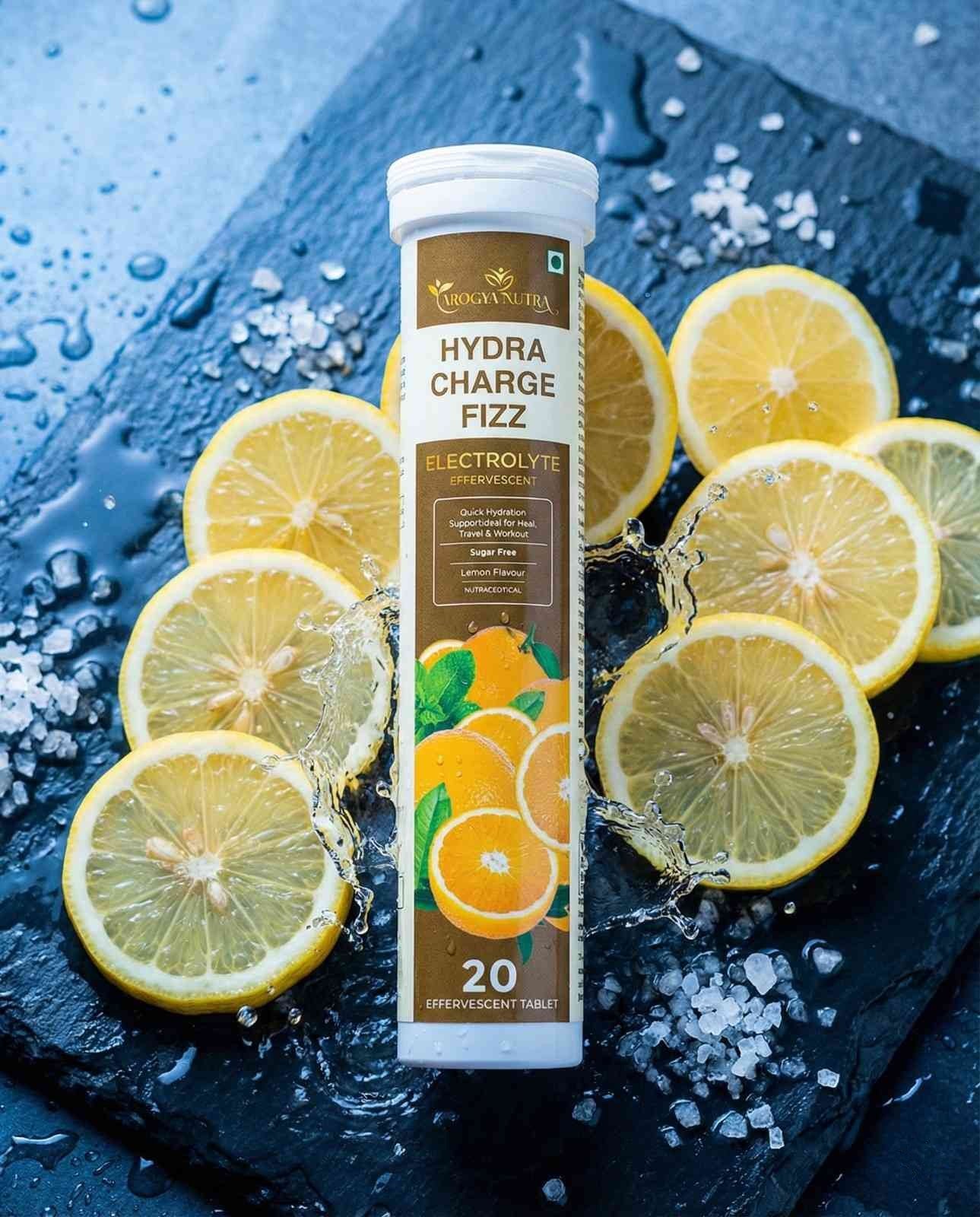Hydra Charge Fizz electrolyte supplement tube with lemon slices on a dark surface